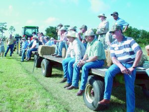 photo of Pasture Weed Day 2007 attendees riding on flat bed trucks for the field tour